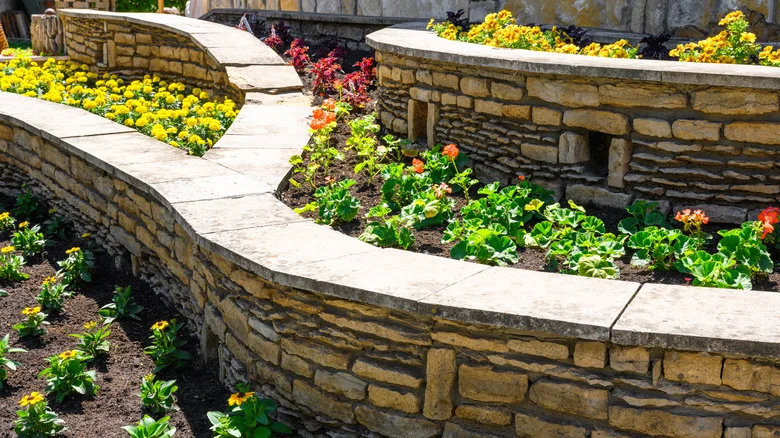All The Benefits Of Planting Your Favorite Blooms In A Stone Wall Flower Bed