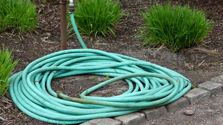 Use A Plastic Bottle To Keep Garden Hoses Neat & Organized